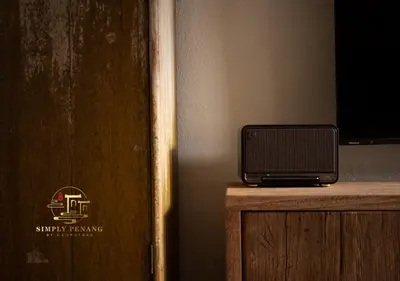 a small television sitting on top of a wooden table at Lumut Heritage - a walk to Armenian St Art & Cafes in George Town