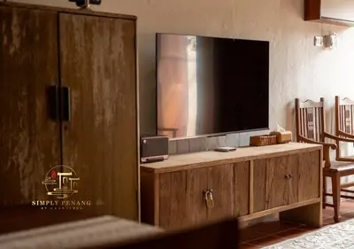 a living room with a large tv on a wooden cabinet at Lumut Heritage - a walk to Armenian St Art & Cafes in George Town