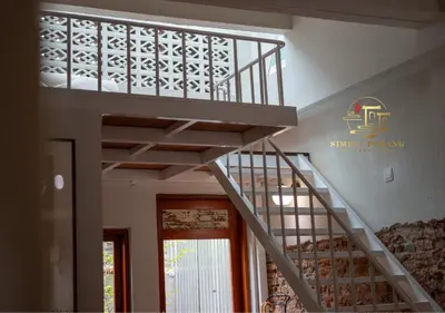 a staircase in a building with a sign on the wall at Lumut Heritage - a walk to Armenian St Art & Cafes in George Town