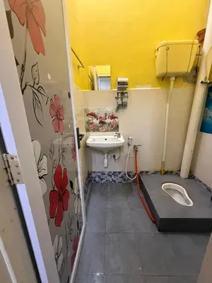 a small bathroom with a sink and a toilet at JJ Homestay Taman Manggis in Balik Pulau