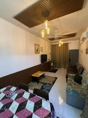 a living room with a couch and a table at JJ Homestay Taman Manggis in Balik Pulau