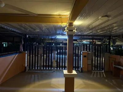 a black gate with a pole in front of it at JJ Homestay Taman Manggis in Balik Pulau