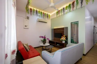 a living room with a couch and a tv at Gaia Realty Homestay, Private & Convenient Stay in Georgetown in George Town
