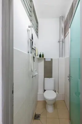 a small bathroom with a toilet and a shower at Gaia Realty Homestay, Private & Convenient Stay in Georgetown in George Town