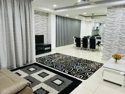 a living room with a couch and a dining room at Residensi Seri Pauh in Bukit Mertajam