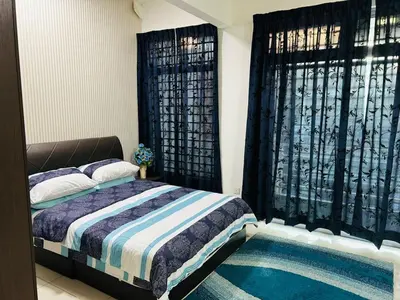 a bedroom with a bed and two windows at Residensi Seri Pauh in Bukit Mertajam