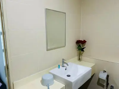 a white bathroom with a sink and a mirror at Residensi Seri Pauh in Bukit Mertajam