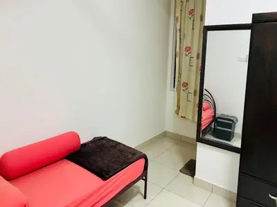 a living room with a red couch and a mirror at Residensi Seri Pauh in Bukit Mertajam
