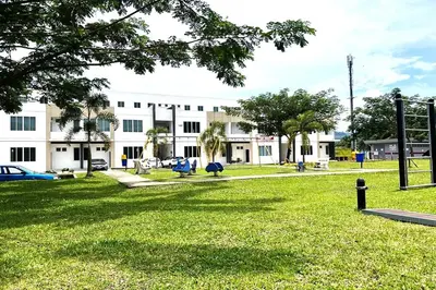 a park in front of a large white building at Homestay MyKulim in Kulim