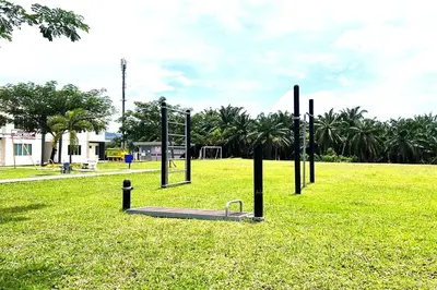a park with a swing set in the grass at Homestay MyKulim in Kulim