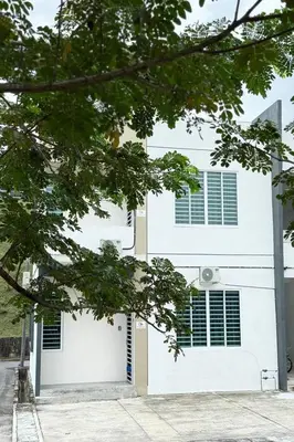 a white house with a white garage door at Homestay MyKulim in Kulim