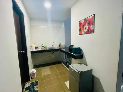 a small kitchen with a sink and a refrigerator at RZHOMESTAy in Gua Musang