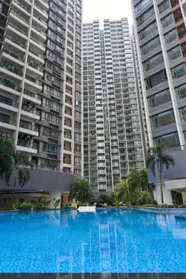 a large swimming pool in front of two tall buildings at Princess Cove R&F Luxury apartment with 3 rooms and 2 bathrooms, for 4-6 people, close to the checkpoint, less than 5 minutes away in Gua Sai