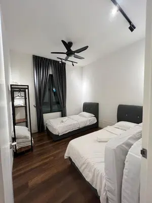 a bedroom with two beds and a ceiling fan at Sunway Onsen 4-6pax in Kampong Batu Lapan