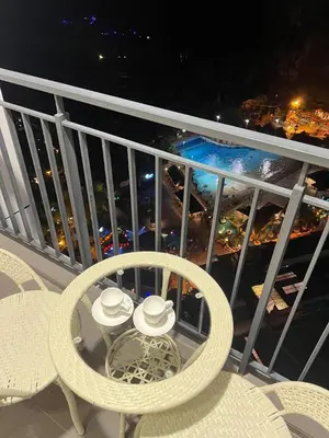 a balcony with a table and two hats on it at Sunway Onsen 4-6pax in Kampong Batu Lapan