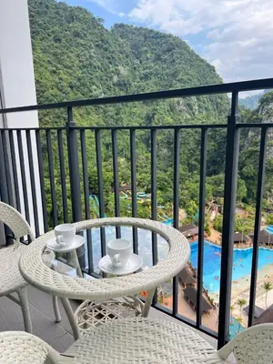 a balcony with a table and chairs and a view of a resort at Sunway Onsen 4-6pax in Kampong Batu Lapan