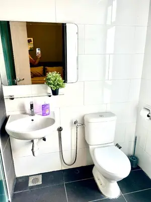a bathroom with a toilet and a sink and a mirror at Ipoh Town Majestic Rena 3R2B 10pax Free 2 carpark in Ipoh