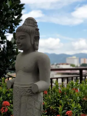 a statue in front of a garden with flowers at Ipoh Town Majestic Rena 3R2B 10pax Free 2 carpark in Ipoh