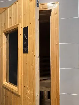 a wooden door with a window in a building at Sunway Onsen Cozy view 4-6pax in Kampong Batu Lapan