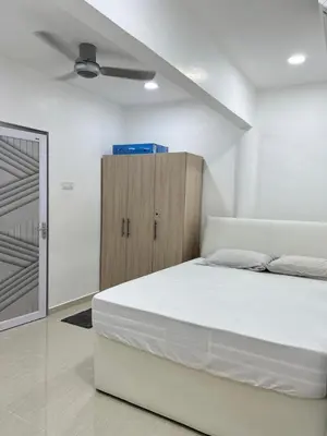 a bedroom with a white bed and a wooden cabinet at BungalowD Pool Villa 7R6B with Netflix Enjoyable Movies & Dramas in Ipoh