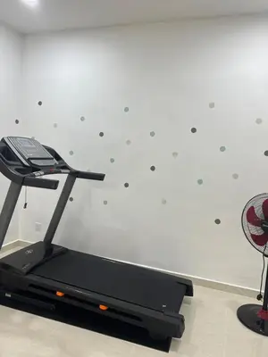 a treadmill in a room with a wall at BungalowD Pool Villa 7R6B with Netflix Enjoyable Movies & Dramas in Ipoh