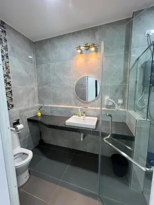 a bathroom with a sink and a toilet and a mirror at BungalowD Pool Villa 7R6B with Netflix Enjoyable Movies & Dramas in Ipoh