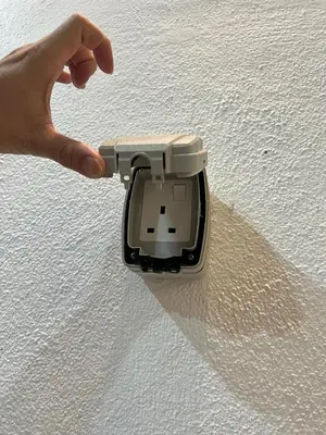 a hand holding a device on top of a table at BungalowD Pool Villa 7R6B with Netflix Enjoyable Movies & Dramas in Ipoh
