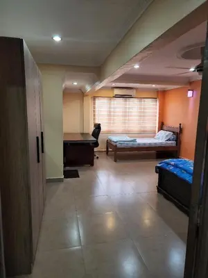 a room with two beds and a pool table at Kinrara HomeStay right at the Heart of Puchong in Gua Sai