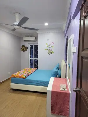 a bedroom with a blue bed in a room at Kinrara HomeStay right at the Heart of Puchong in Gua Sai