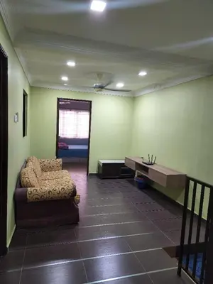 a living room with a couch and a table at Kinrara HomeStay right at the Heart of Puchong in Gua Sai