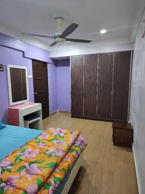 a bedroom with a bed and a ceiling fan at Kinrara HomeStay right at the Heart of Puchong in Gua Sai
