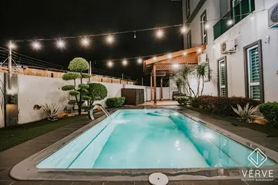 a swimming pool in the yard of a house at night at Ipoh VastBlue Escape Pool Villa 6B6B 23Pax in Ipoh