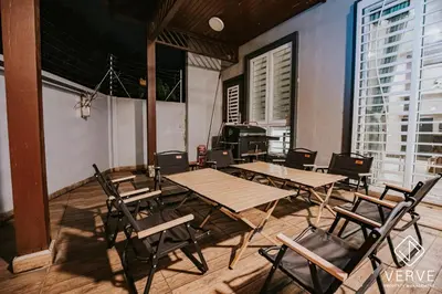 a group of tables and chairs in a room with windows at Ipoh VastBlue Escape Pool Villa 6B6B 23Pax in Ipoh