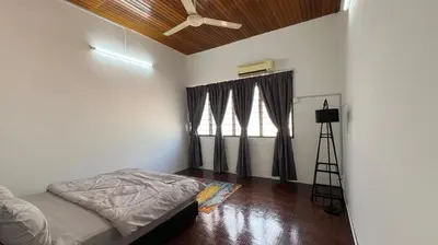 a bedroom with a bed and a ceiling fan at PJ Homestay in Bayan Lepas