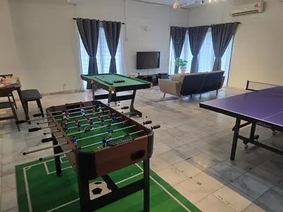 a living room with two ping pong tables at PJ Homestay in Bayan Lepas