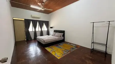a bedroom with a bed and a rug at PJ Homestay in Bayan Lepas
