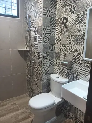 a bathroom with a toilet and a sink and a shower at Karasky Hotel in Simpang Ampat