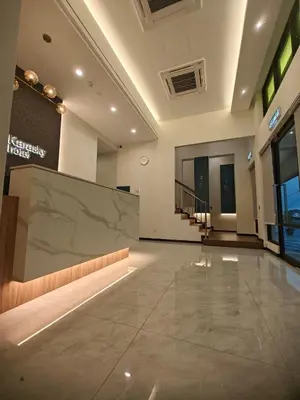 a large room with a large projection screen in a building at Karasky Hotel in Simpang Ampat