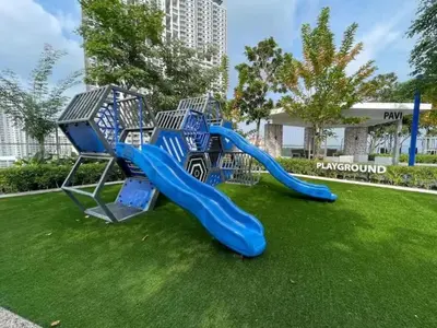 a blue slide on the grass in a park at Breezy Urban 6pax SeaView InfinityPool Georgetown in George Town