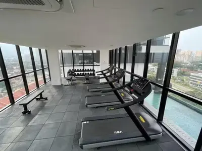 a gym with a row of treadmills and a pool at Breezy Urban 6pax SeaView InfinityPool Georgetown in George Town