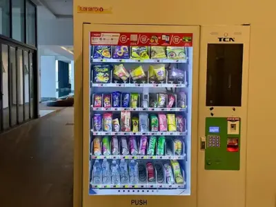 a vending machine filled with drinks and soft drinks at Breezy Urban 6pax SeaView InfinityPool Georgetown in George Town
