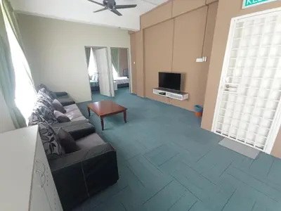 a living room with a couch and a tv at DarulMakmur Apartment in Brinchang