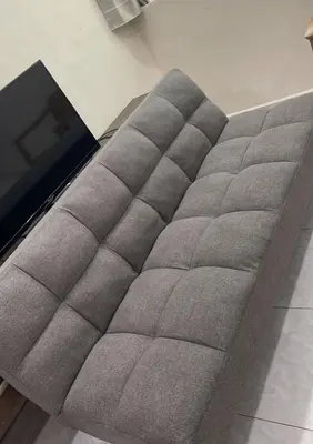 a gray couch with a television on top of it at \u60a6\u5ba2YK Homestay 5mins to IconCity in Bukit Mertajam