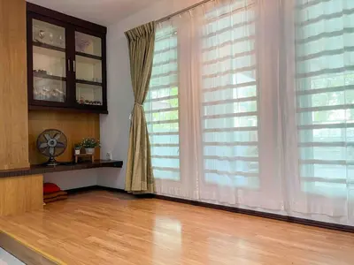 a room with a large window with curtains and a wooden floor at \u60a6\u5ba2YK Homestay 5mins to IconCity in Bukit Mertajam