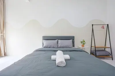 a bed with two towels on top of it at Cool Climate Comfort Brinchang Cameron Highlands Holiday Clover Home 4-27 in Brinchang