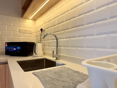 a kitchen with a sink and aaucet at Iconic Regency Seaview Homestay with Rooftop Pool in Bayan Lepas