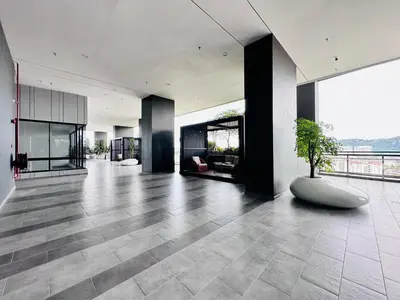 a lobby with a plant in the middle of a building at Iconic Regency Seaview Homestay with Rooftop Pool in Bayan Lepas