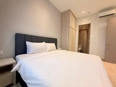 a bedroom with a large white bed with a black headboard at Iconic Regency Seaview Homestay with Rooftop Pool in Bayan Lepas