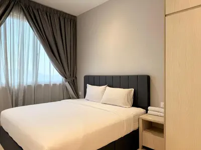 a bedroom with a large bed with a window at Iconic Regency Seaview Homestay with Rooftop Pool in Bayan Lepas