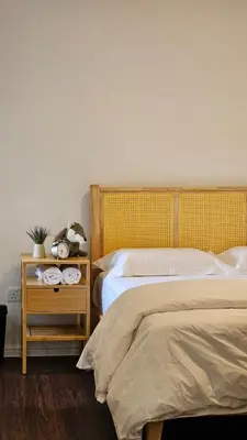 a bedroom with two beds and a nightstand with a bed sidx sidx at Kea Farm Stay in Brinchang